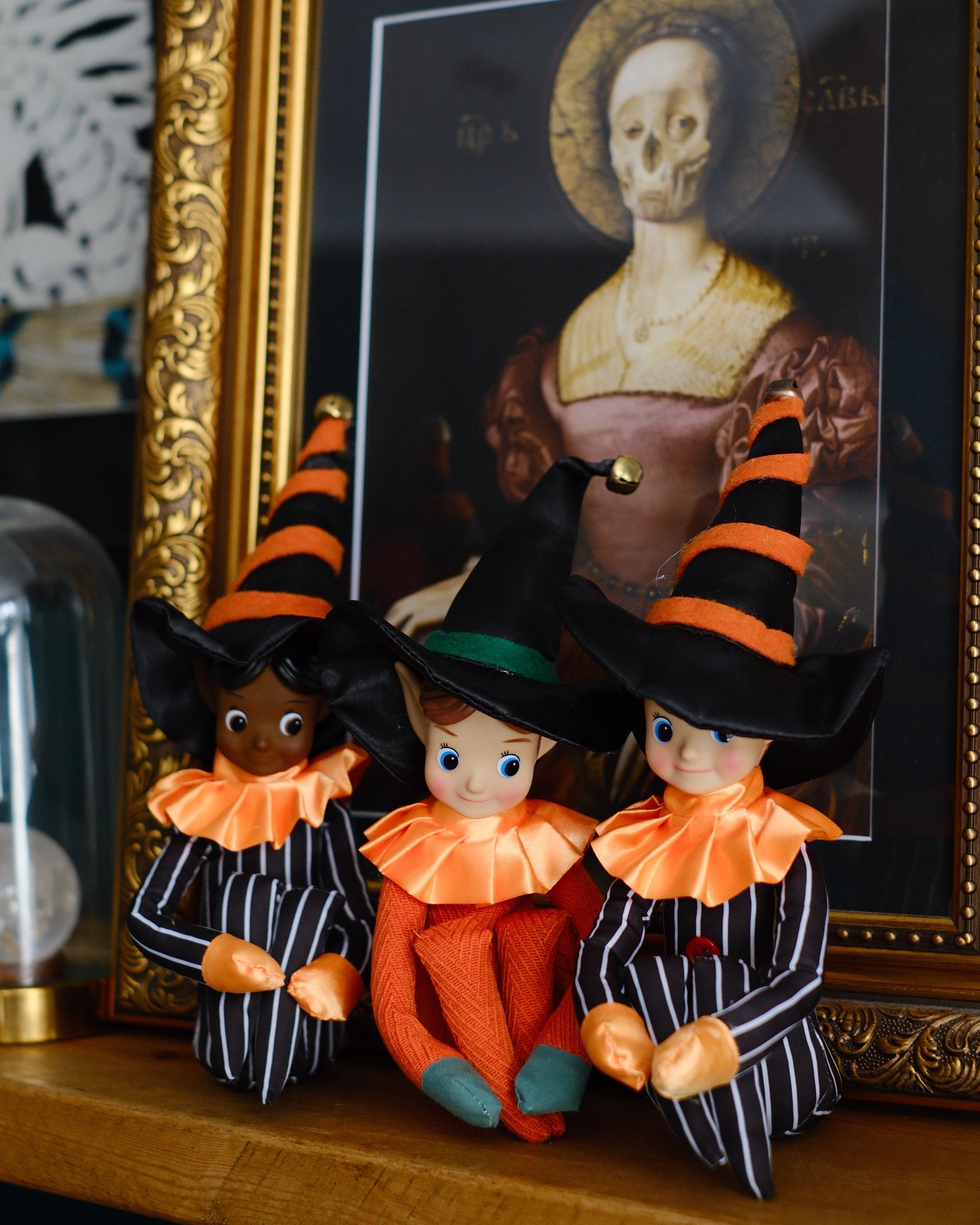 Decorative Halloween-themed elveswith a framed portrait in the background